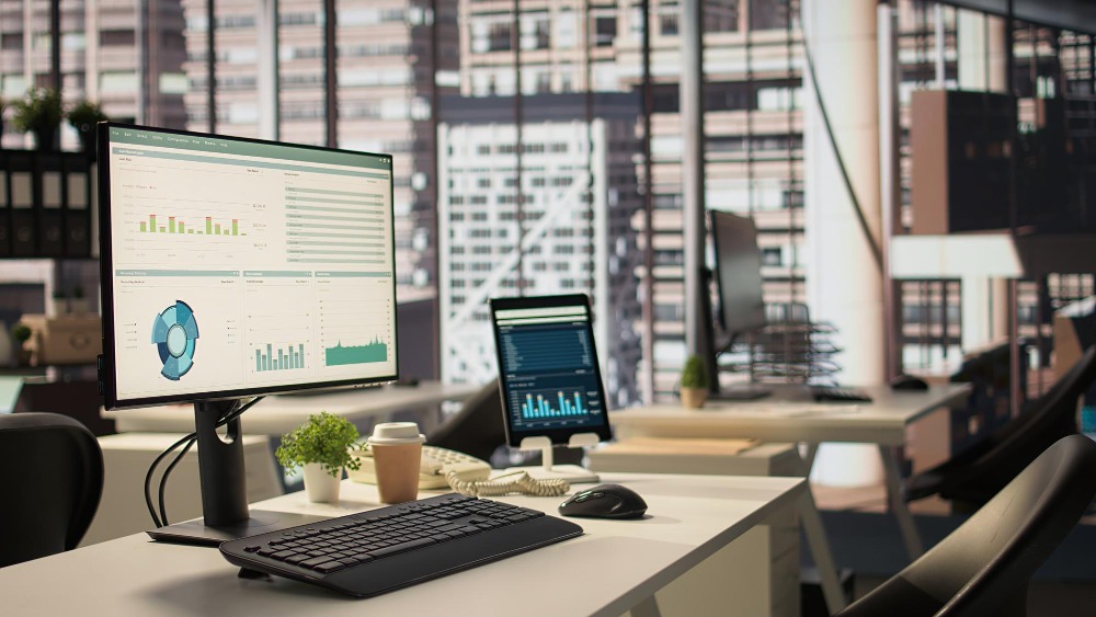 Laptop in front of a wide window to represent workplace asset management